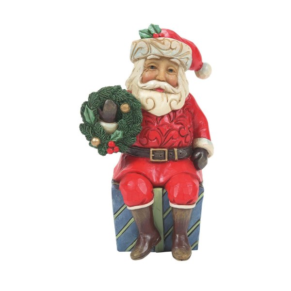 Der Weihnachtsmann sitzt auf einem Geschenk – JIM SHORE HEARTWOOD CREEK