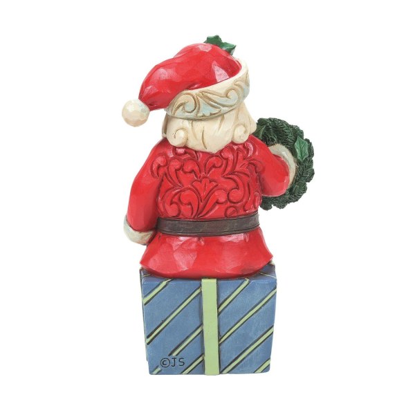 Der Weihnachtsmann sitzt auf einem Geschenk – JIM SHORE HEARTWOOD CREEK